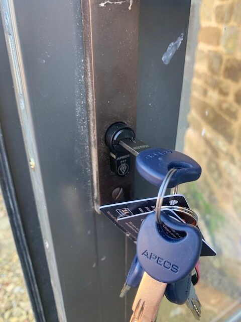Black Apecs AP cylinder lock fitted to uPVC door for enhanced security in Kidlington